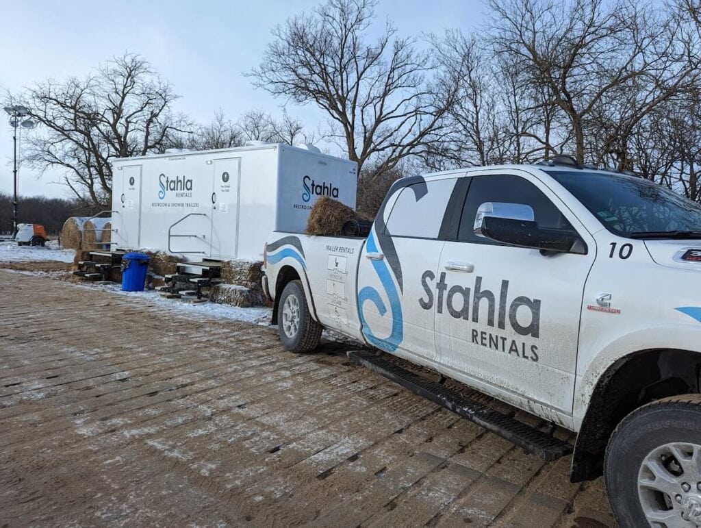 Stahla rentals truck and restroom trailers in outdoor setting.