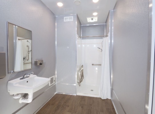Modern bathroom with shower and sink.