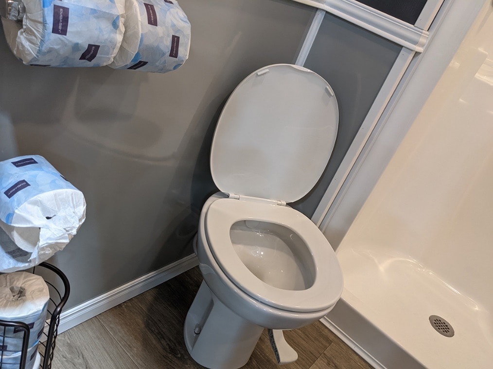 White toilet next to shower in modern bathroom.