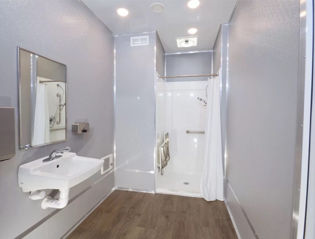 Modern bathroom with shower, sink, and mirror.