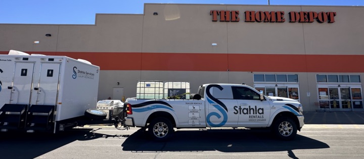The Home Depot store exterior with rental truck parked outside.