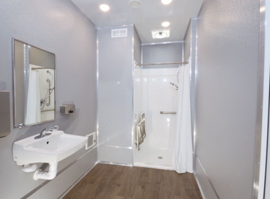 Modern bathroom with shower and sink.