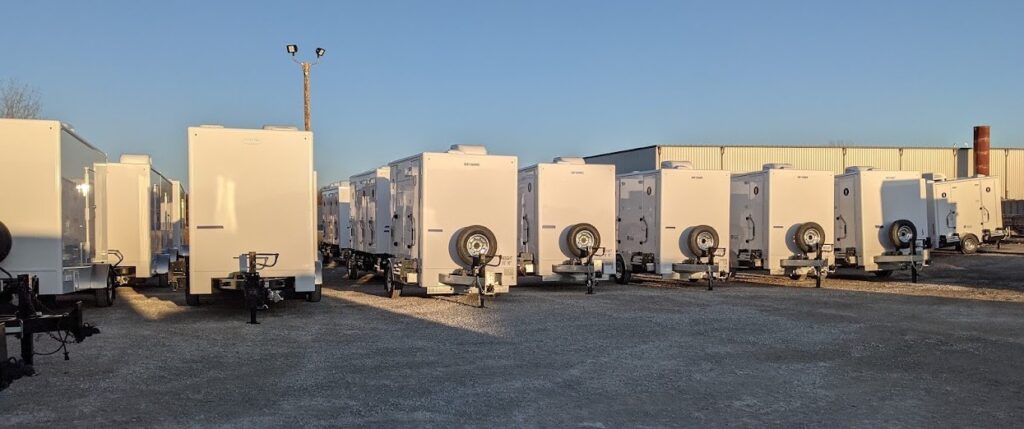 Row of white refrigerated trailers at storage yard.