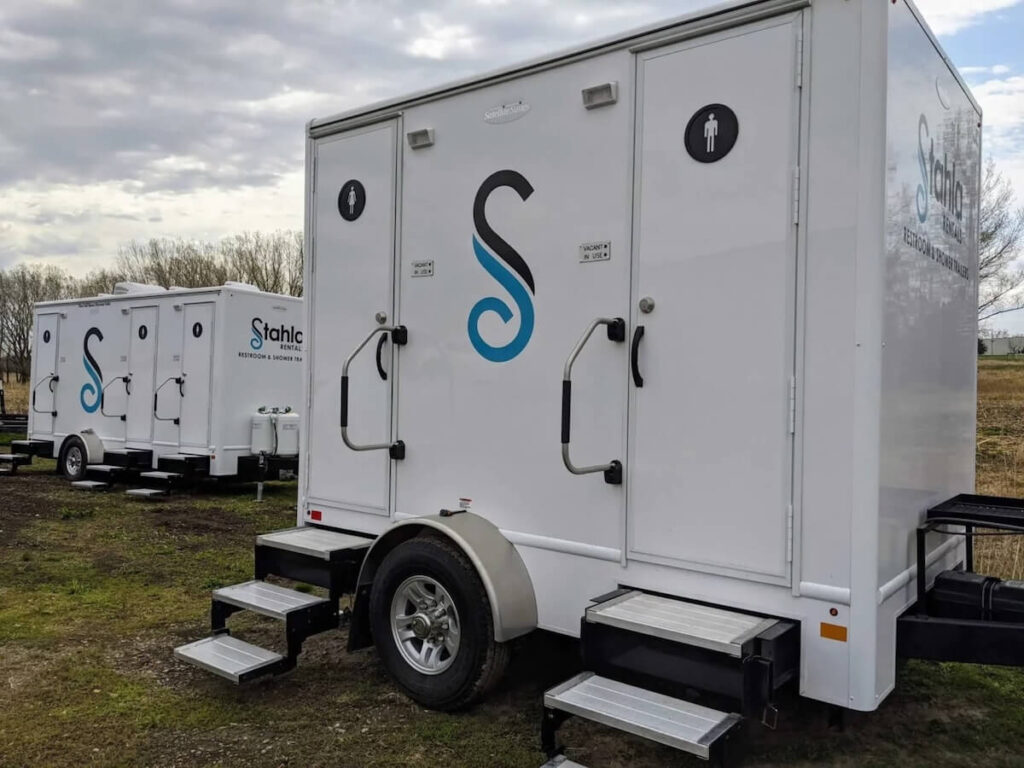 Portable 2 STall restroom trailers in outdoor setting.