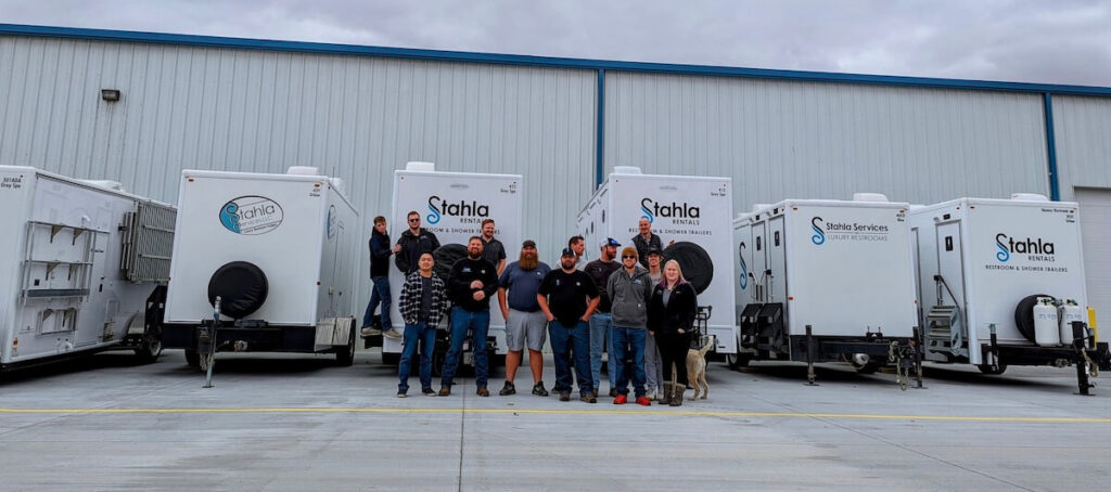 Team by mobile restroom trailers at industrial facility