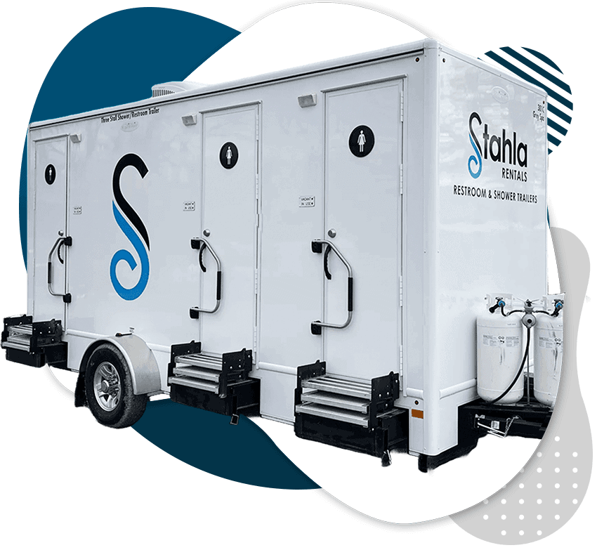 A portable restroom trailer operated by stahla rentals with external steps and hand sanitizing stations.
