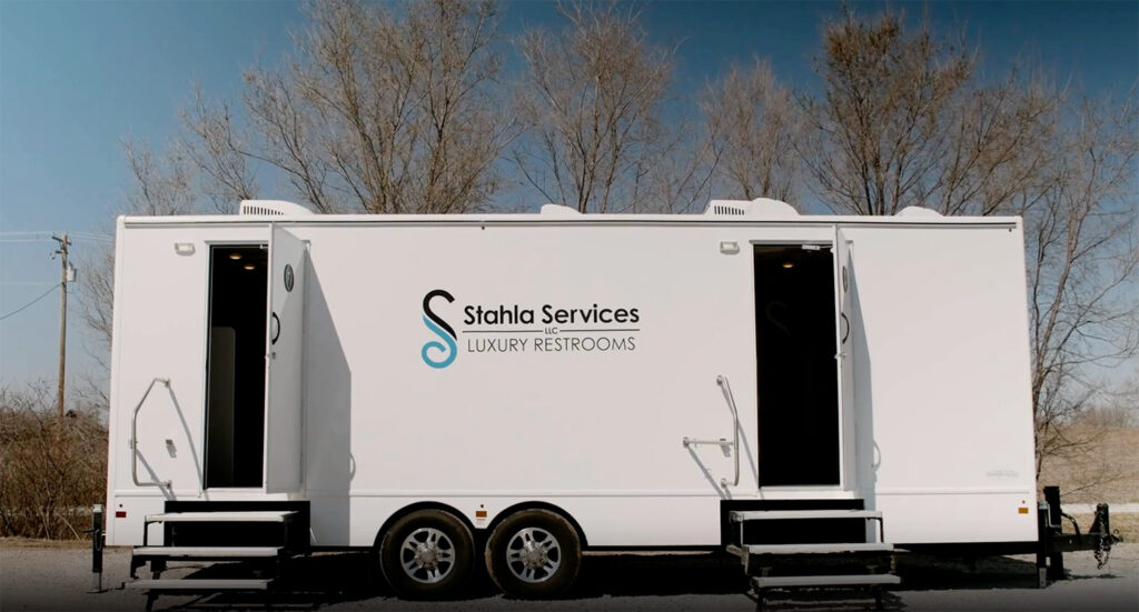 Mobile luxury restroom trailer parked outdoors.