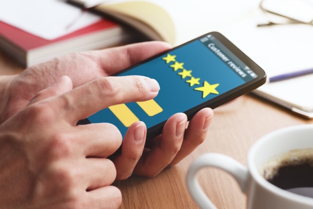 Person rating service on smartphone app with stars.