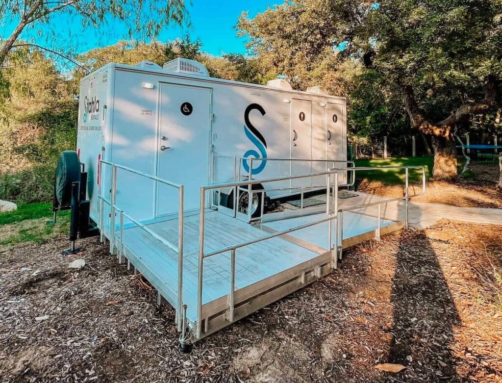Portable ADA Compliant restroom trailer in park setting
