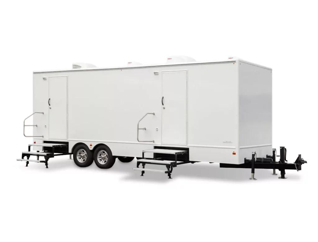 a large white 10 stall restroom trailer with dual axles and side doors, equipped with external steps, parked on a white background.