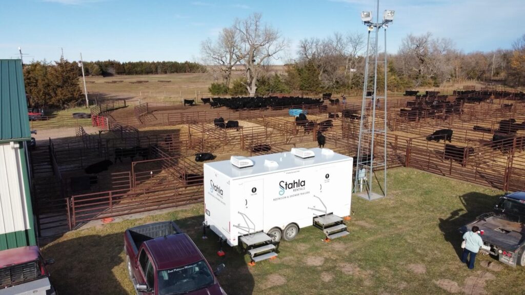 Aerial view of cattle pens and mobile restroom unit.