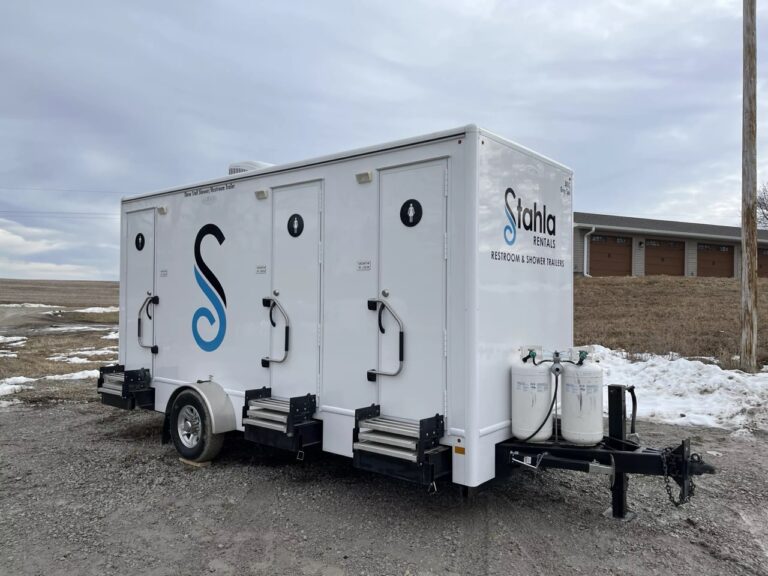Mobile restroom and shower trailer parked outdoors.