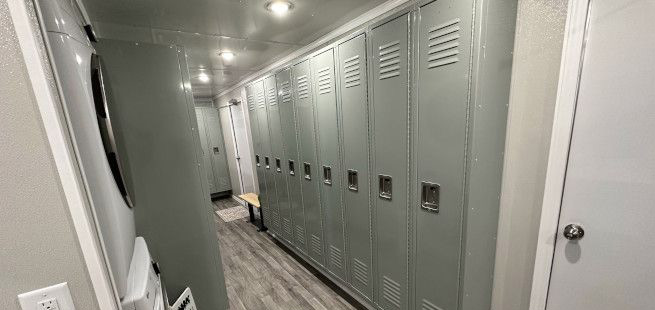 Interior hallway with gray lockers on side.