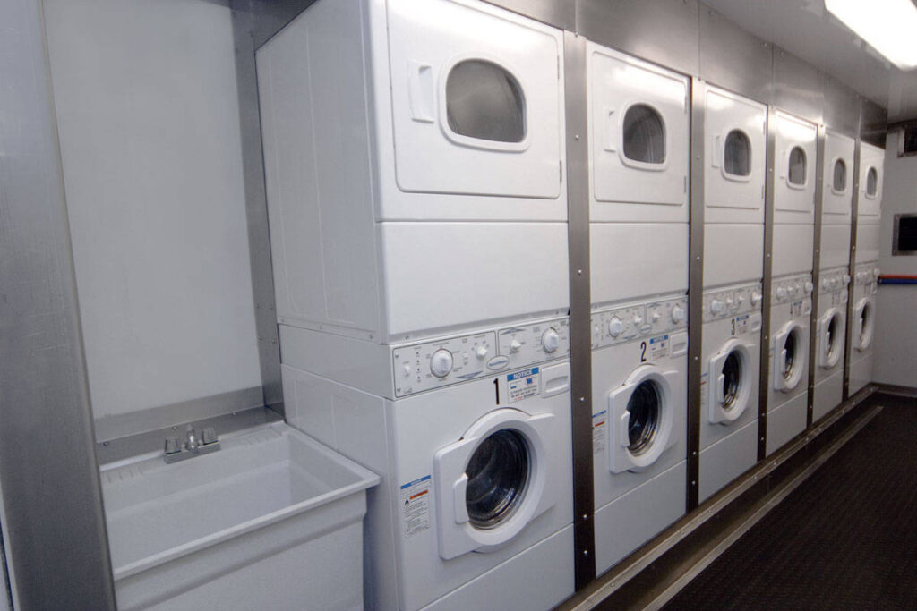Row of washing machines in laundry trailer by stahla services
