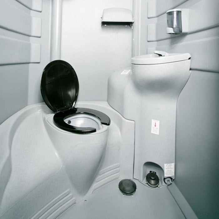Compact airplane lavatory interior with toilet and sink.