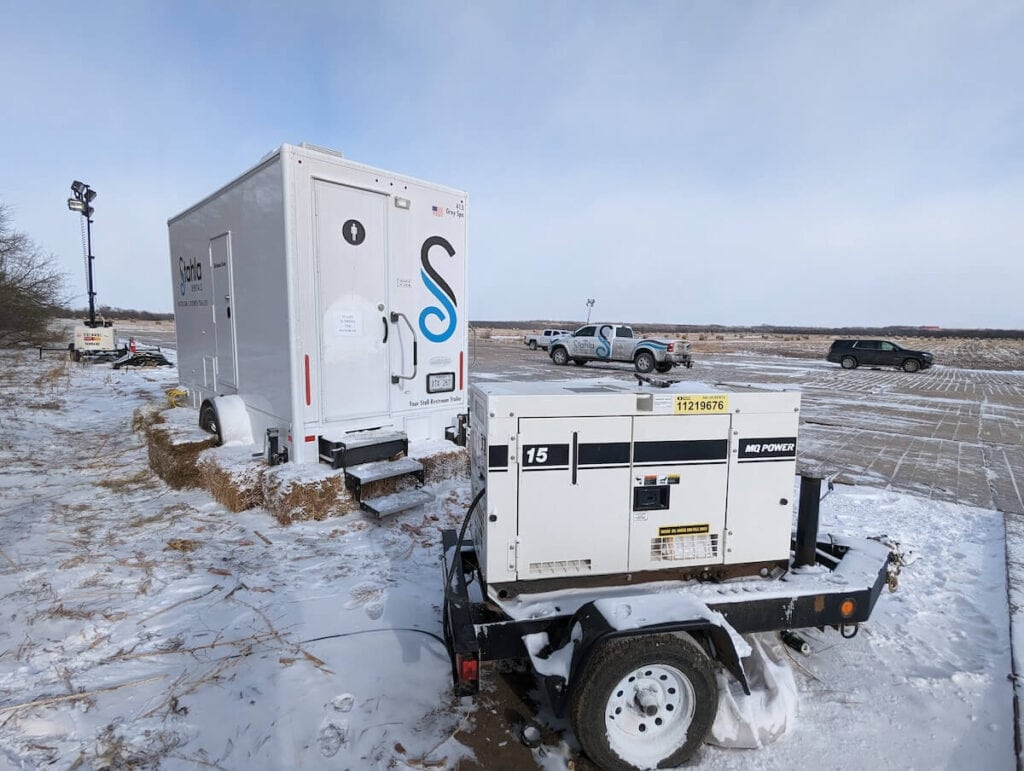 Mobile fuel station and generator in snowy field.