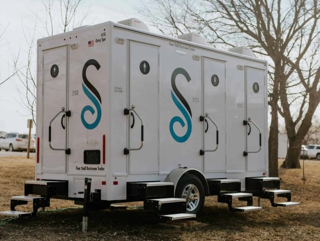 Mobile restroom trailer parked outdoors.