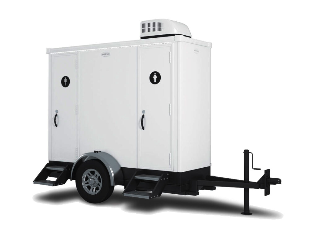 Portable restroom trailer with steps and wheels.