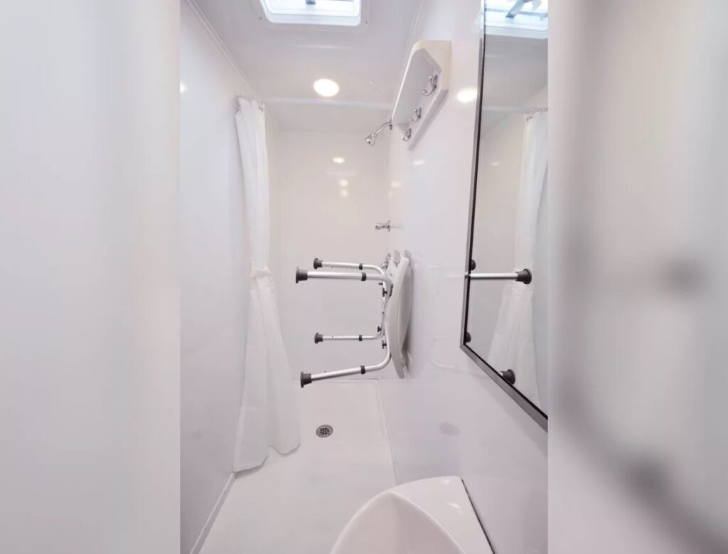 Modern white bathroom interior with accessibility features.