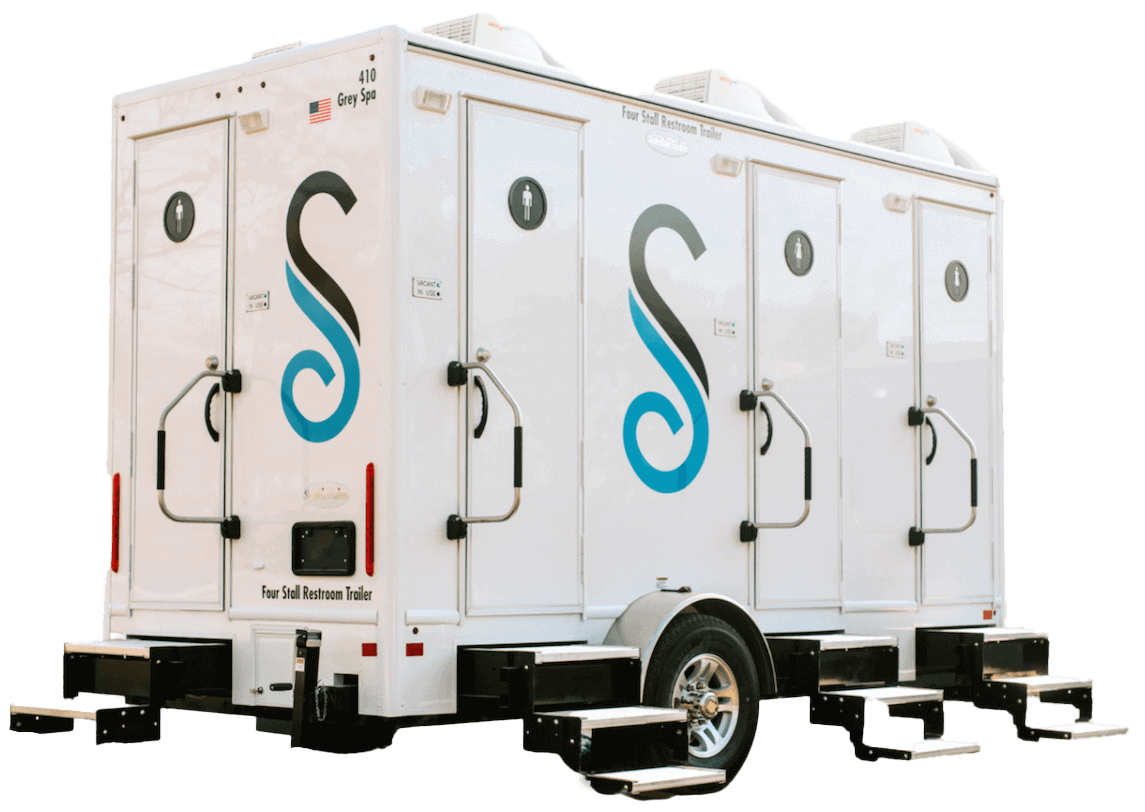 Mobile four-stall restroom trailer with logo.