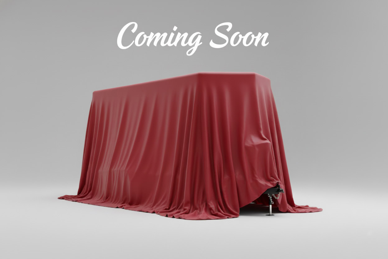 A large rectangular object covered by a red cloth stands on a gray background with the words "Coming Soon" above it.